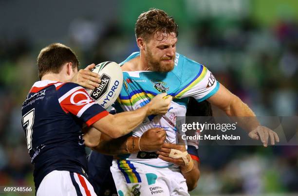 Elliot Whitehead of the Raiders is tackled during the round 12 NRL match between the Canberra Raiders and the Sydney Roostrers at GIO Stadium on May...