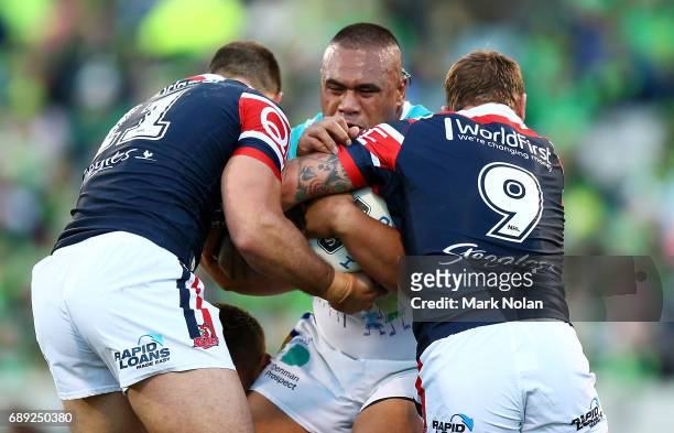 Junior Paulo of the Raiders is tackled during the round 12 NRL match between the Canberra Raiders and the Sydney Roostrers at GIO Stadium on May 28,...
