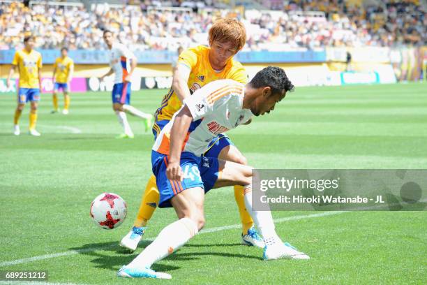 Musashi Suzuki of Albirex Niigata controls the ball under pressure of Yasuhiro Hiraoka of Vegalta Sendai during the J.League J1 match between Vegalta...