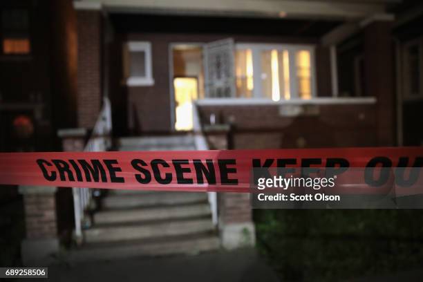 Crime scene tape is stretched around the front of a home where a man was shot on May 28, 2017 in Chicago, Illinois. Chicago police have added more...