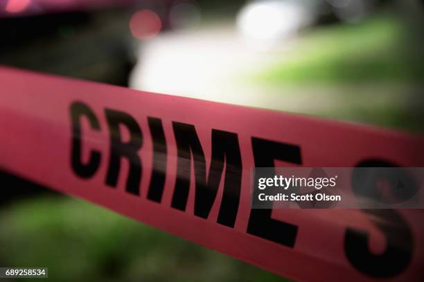 Crime scene tape is stretched around the front of a home where a man was shot on May 28, 2017 in Chicago, Illinois. Chicago police have added more...