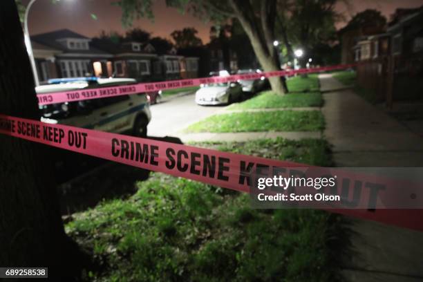 Crime scene tape is stretched around the front of a home where a man was shot on May 28, 2017 in Chicago, Illinois. Chicago police have added more...