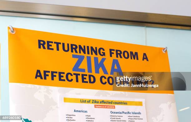 valletta, malta: warning sign for zika virus at ferryboat station - zika stock pictures, royalty-free photos & images