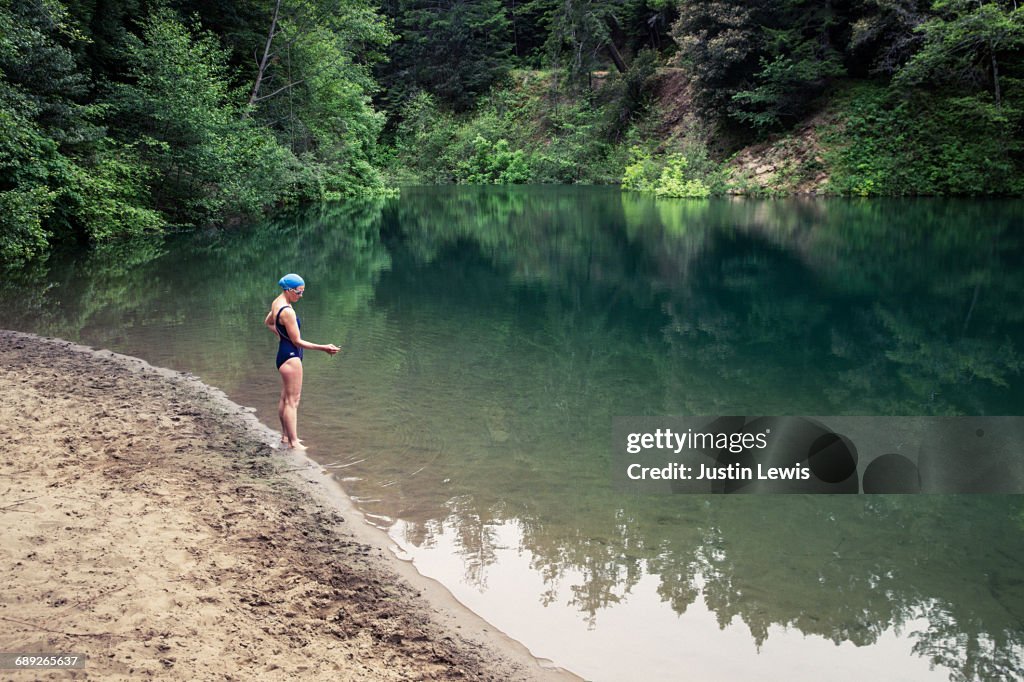 Middle Aged Woman Ready to Jump in River to Swim