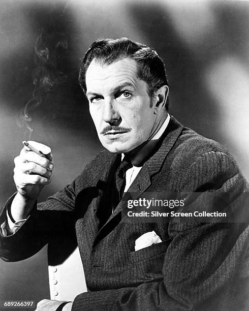 American actor Vincent Price smoking a cigarette, circa 1955.