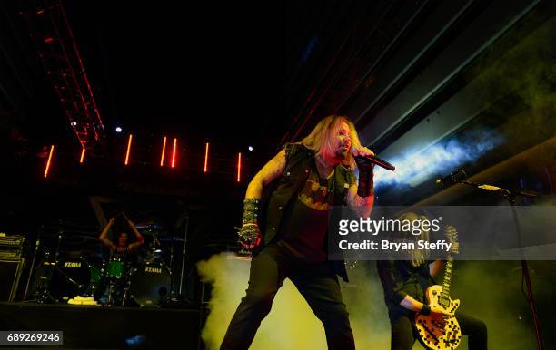 Drummer Zoltan Chaney of Slaughter, singer Vince Neil and guitarist Jeff Blando" Bland of Slaughter perform during the "Rock the Street" Memorial Day...
