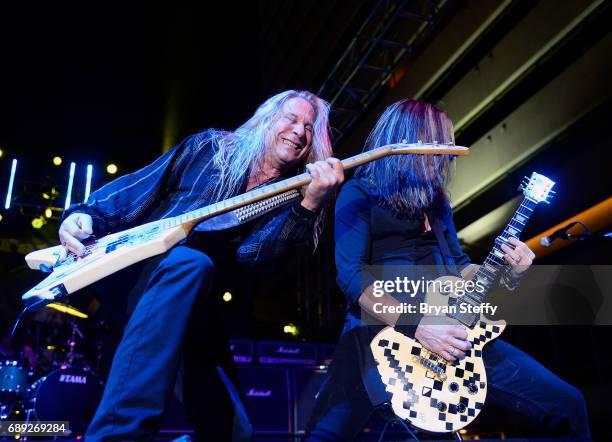 Bassist Dana Strum and guitarist Jeff Blando" Bland of Slaughter perform with Vince Neil during the "Rock the Street" Memorial Day weekend block...