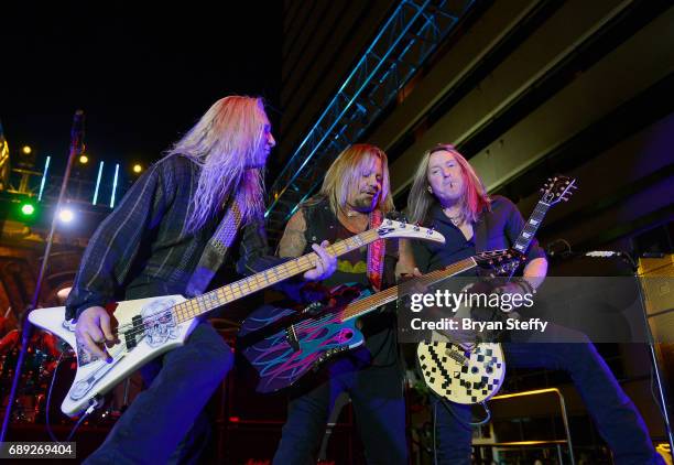 Bassist Dana Strum of Slaughter, singer Vince Neil and guitarist Jeff Blando" Bland of slaughter perform during the "Rock the Street" Memorial Day...