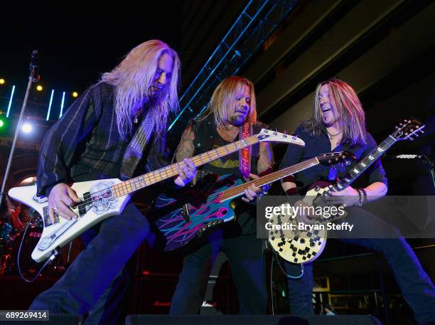 Bassist Dana Strum of Slaughter, singer Vince Neil and guitarist Jeff Blando" Bland of slaughter perform during the "Rock the Street" Memorial Day...