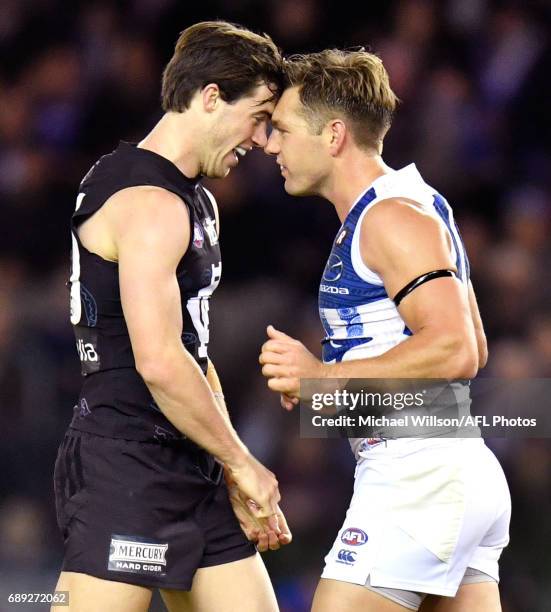 Lachie Plowman of the Blues and Shaun Higgins of the Kangaroos clash during the 2017 AFL round 10 match between the Carlton Blues and the North...