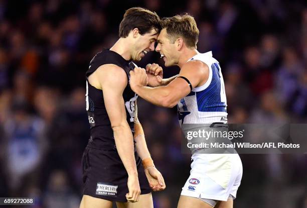 Lachie Plowman of the Blues and Shaun Higgins of the Kangaroos clash during the 2017 AFL round 10 match between the Carlton Blues and the North...