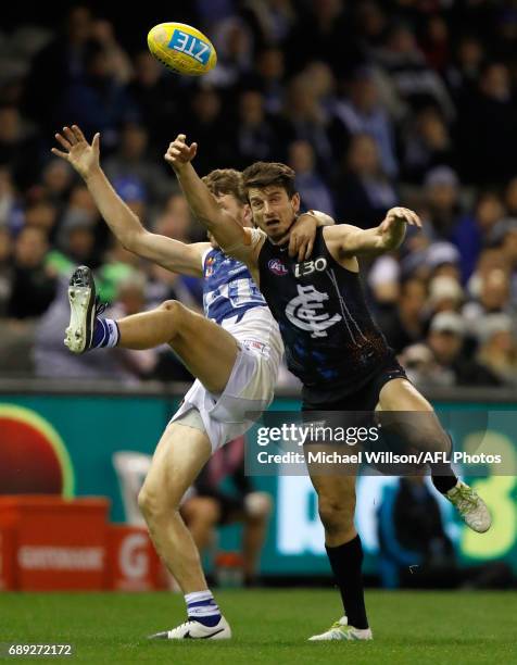 Alex Silvagni of the Blues and Lachlan Hansen of the Kangaroos compete for the ball during the 2017 AFL round 10 match between the Carlton Blues and...