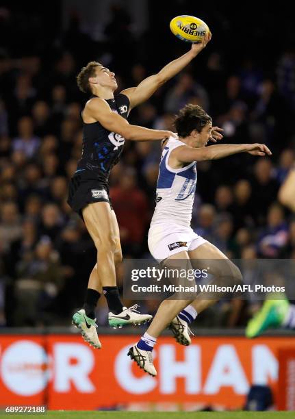 Tom Williamson of the Blues marks the ball over Taylor Garner of the Kangaroos during the 2017 AFL round 10 match between the Carlton Blues and the...