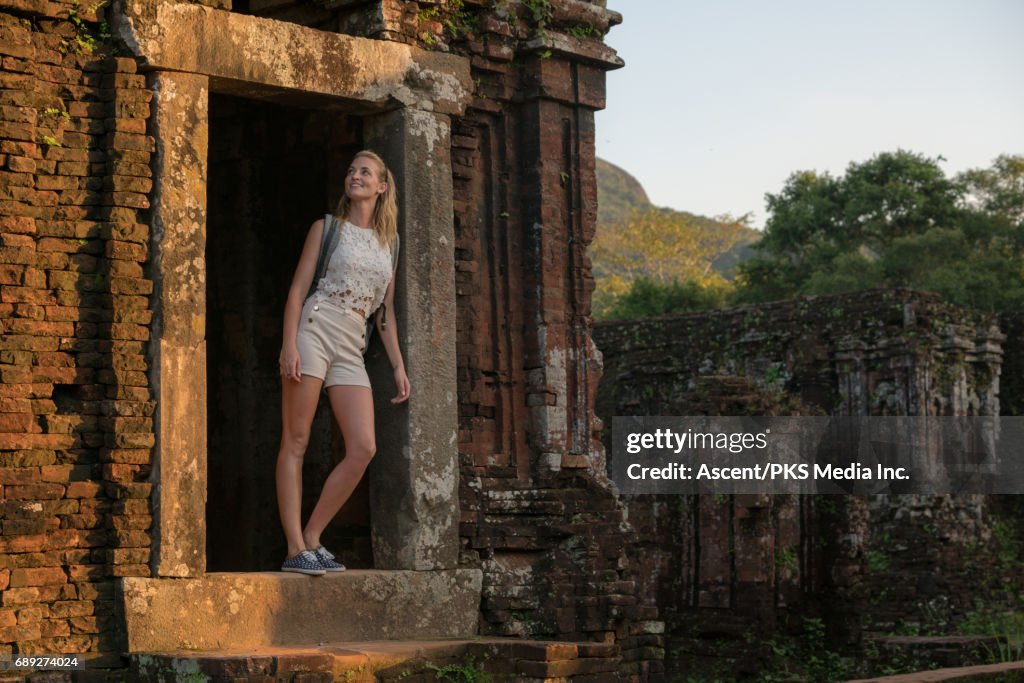 Young woman explores ancient ruins