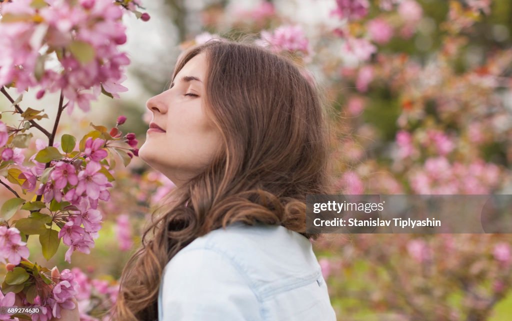 Young girl in an apple orchard.