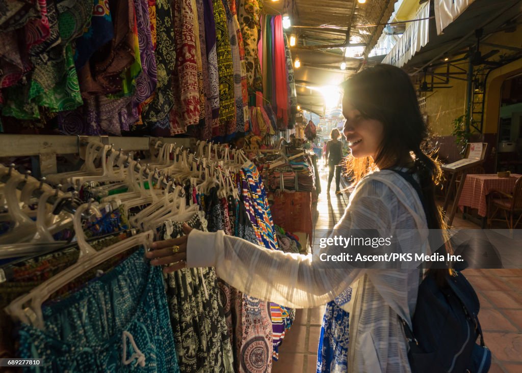 Young woman explores market, local colour