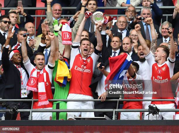 Arsenal captain Per Mertesacker lifts the FA Cup with Jeff Reine-Adelaide, Aaron Ramsey Rob Holding and Alexis Sanchez after the Emirates FA Cup...