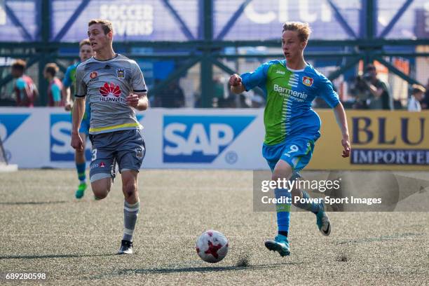 Wellington Phoenix's Liam Wood competes with Bayer Leverkusen's Sam Schreck , for a ball during their Main Tournament Plate Final match, part of the...