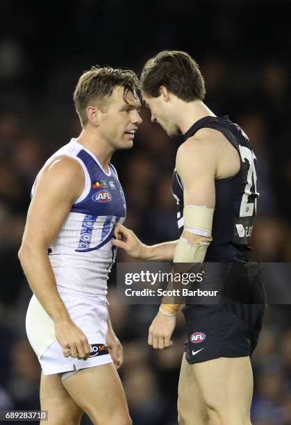 Lachie Plowman of the Blues and Shaun Higgins of the Kangaroos clash during the round 10 AFL match between the Carlton Blues and the North Melbourne...