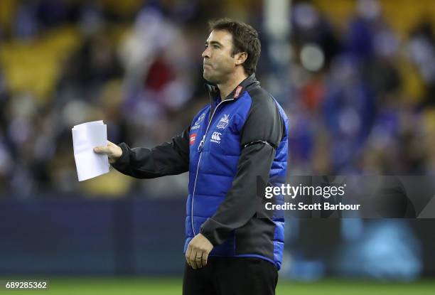 Brad Scott, coach of the Kangaroos speaks to his team during a quarter time break during the round 10 AFL match between the Carlton Blues and the...