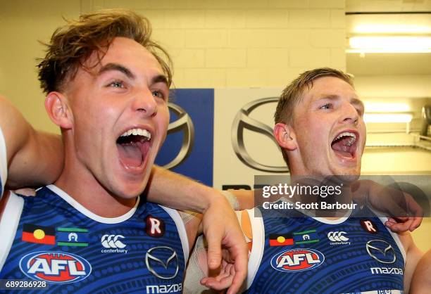 Ryan Clarke and Jack Ziebell sing the song in the rooms after winning during the round 10 AFL match between the Carlton Blues and the North Melbourne...