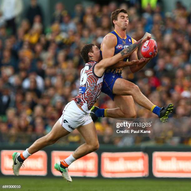 Jamie Cripps of the Eagles contests a mark against Nathan Wilson of the Giants during the round 10 AFL match between the West Coast Eagles and the...