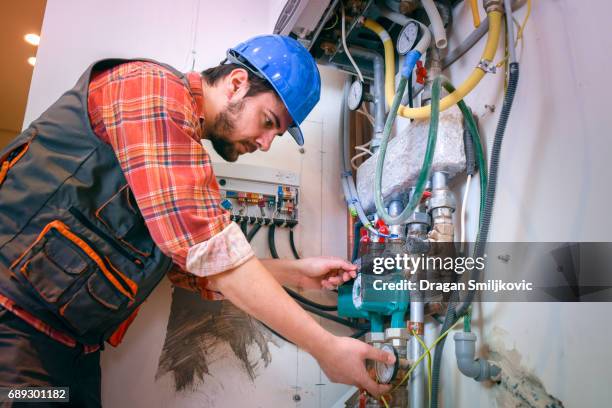 technician installing heating system - temperature stock pictures, royalty-free photos & images