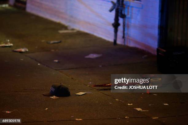 Baseball hat and mobile phone rest next to crime scene tape where a man was shot in the 7100 block of South State Street on May 28, 2017 in Chicago,...