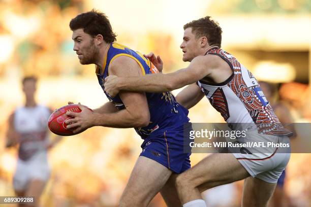 Jeremy McGovern of the Eagles is tackled by Heath Shaw of the Giants during the round 10 AFL match between the West Coast Eagles and the Greater...