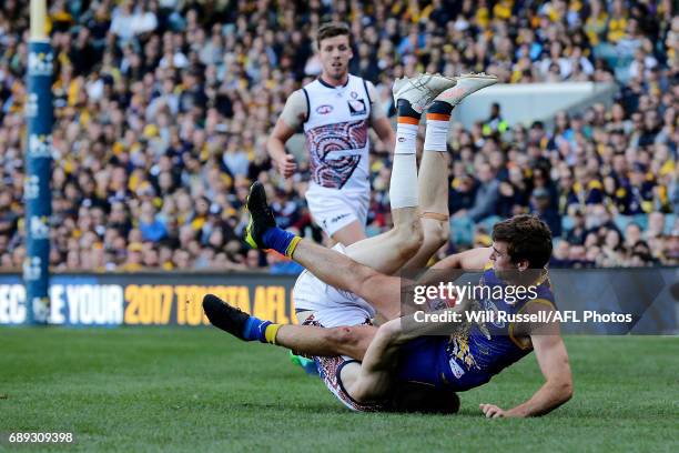 Jamie Cripps of the Eagles is tackled by Jeremy Cameron of the Giants during the round 10 AFL match between the West Coast Eagles and the Greater...