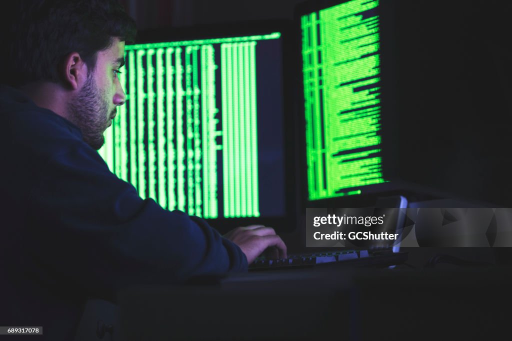 Computer nerd working late on his complex computer algorithms