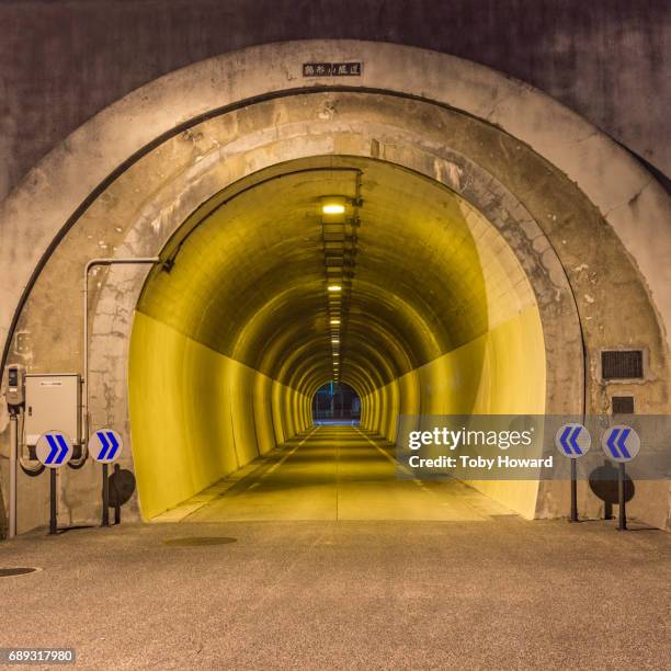 illuminated road tunnel in japan - howard street stock pictures, royalty-free photos & images