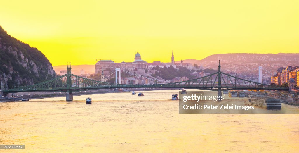 Budapest cityscape at sunset with the Liberty and Elizabeth bridges, and the Buda Castle in the background