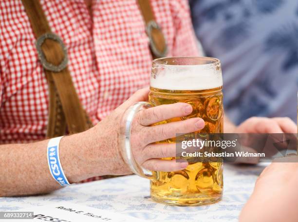 Supporter of the Bavarian Christian Democrats is holding a beer mug at the Trudering fest on May 28, 2017 in Munich, Germany. The CDU and CSU, along...