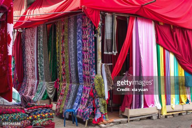 colourful silk fabrics and textile hanging in store,kuqa,china - silk china stock pictures, royalty-free photos & images