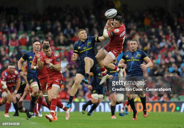 Scarlets' Steffan Evans and Munster's Andrew Conway challenge for the high ball during the Guinness PRO12 Final match between Munster and Scarlets at...