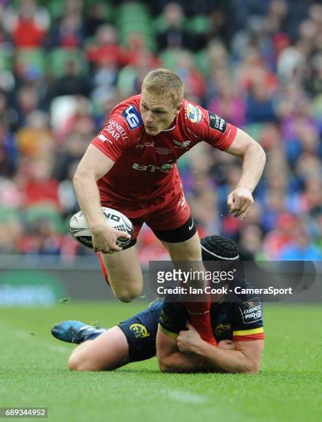 Scarlets' Steffan Evans is tackled by Munster's Tyler Bleyendaal during the Guinness PRO12 Final match between Munster and Scarlets at the Aviva...