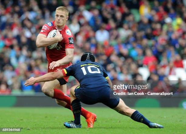 Scarlets' Steffan Evans takes on Munster's Tyler Bleyendaal during the Guinness PRO12 Final match between Munster and Scarlets at the Aviva Stadium...