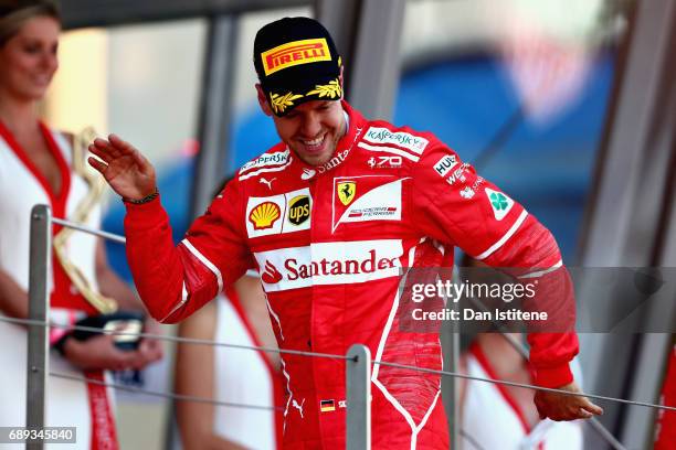 Sebastian Vettel of Germany and Ferrari celebrates his race win on the podium during the Monaco Formula One Grand Prix at Circuit de Monaco on May...