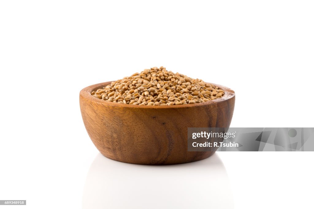 Grain wheat in wooden bowl