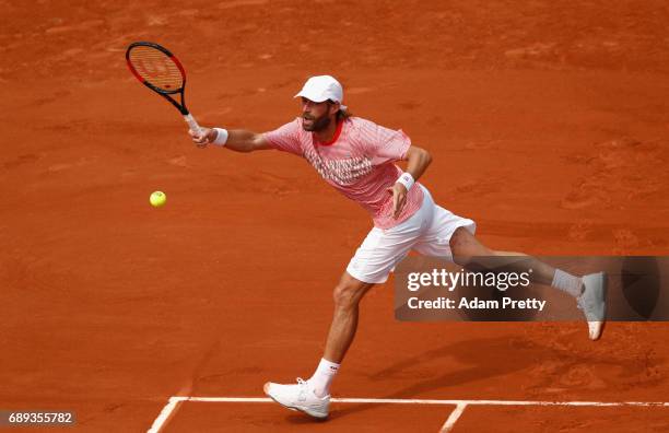 Stephane Robert of France plays a forehand during the mens singles first round match against Grigor Dimitrov of Bulgaria on day one of the 2017...