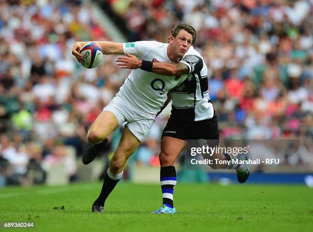 Sam James of England is tackled by Kahn Fotuali'i of Barbarians during the Old Mutual Wealth Cup match between England and Barbarians at Twickenham...