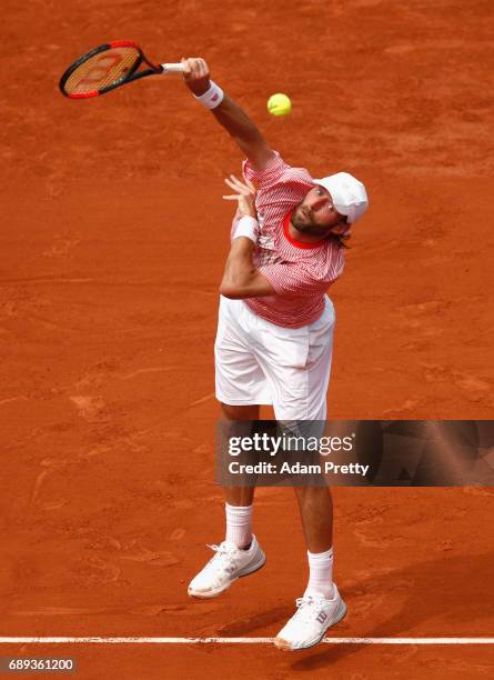Stephane Robert of France serves during the mens singles first round match against Grigor Dimitrov of Bulgaria on day one of the 2017 French Open at...