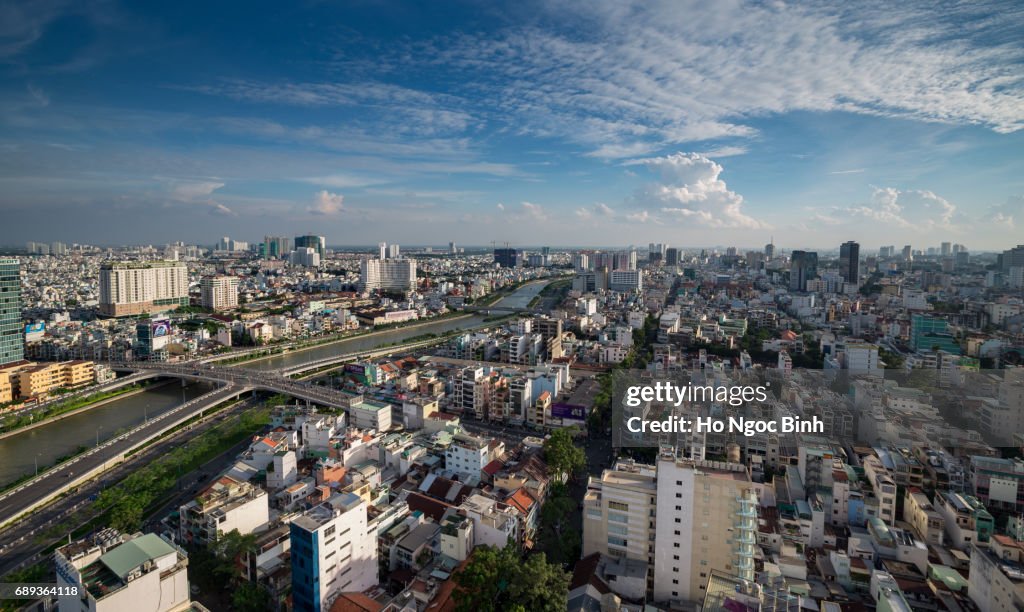 Aerial sunset view of houses and Business and Administrative Center of Ho Chi Minh city on NHIEU LOC canal