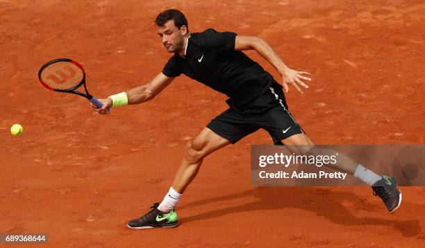 Grigor Dimitrov of Bulgaria plays a forehand during the mens singles first round match against Stephane Robert of France son day one of the 2017...