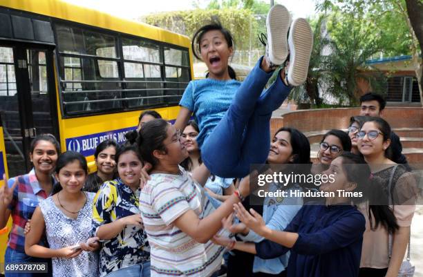 Students celebrate after the CBSE class 12th results 2017 announced at Blue Bells Model School sector-4, on May 28, 2017 in Gurugram, India. A total...