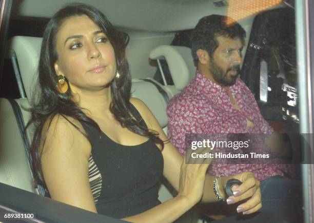 Bollywood director Kabir Khan with his wife Mini Mathur arrive to attend the 45th birthday celebration party of filmmaker Karan Johar at his...