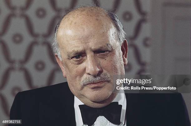 English film producer Michael Balcon pictured wearing a black bow tie at an arts function in London in November 1970.
