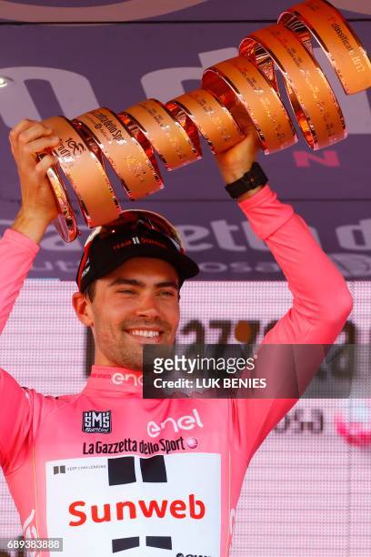 The winner of the 100th Giro d'Italia, Tour of Italy cycling race, Netherlands' Tom Dumoulin of team Sunweb holds the trophy on the podium after the...