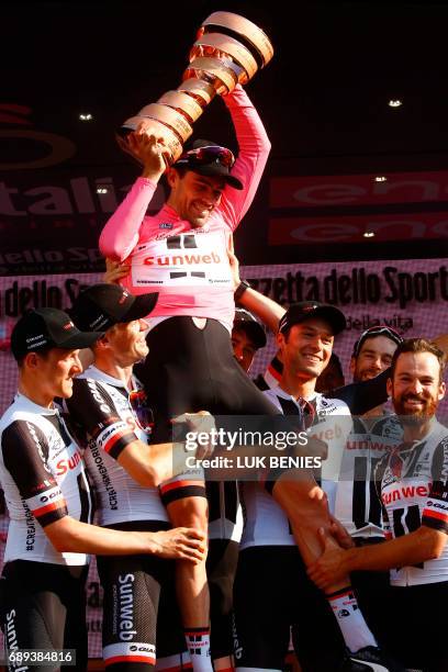 The winner of the 100th Giro d'Italia, Tour of Italy cycling race, Netherlands' Tom Dumoulin of team Sunweb celebrates with teammates on the podium...